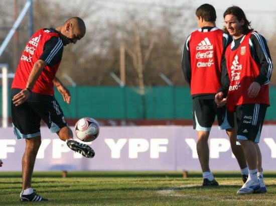 A ver si te sale ésta... Juan Sebastián Verón parece querer desafiar a Messi, que mira la destreza de su compañero.