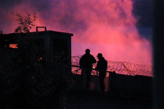 Guardias en la muralla mientras el humo sale desde el Pabellón Nº 1. La calma regresó pasadas las 22, cuando se autorizó la salida. 